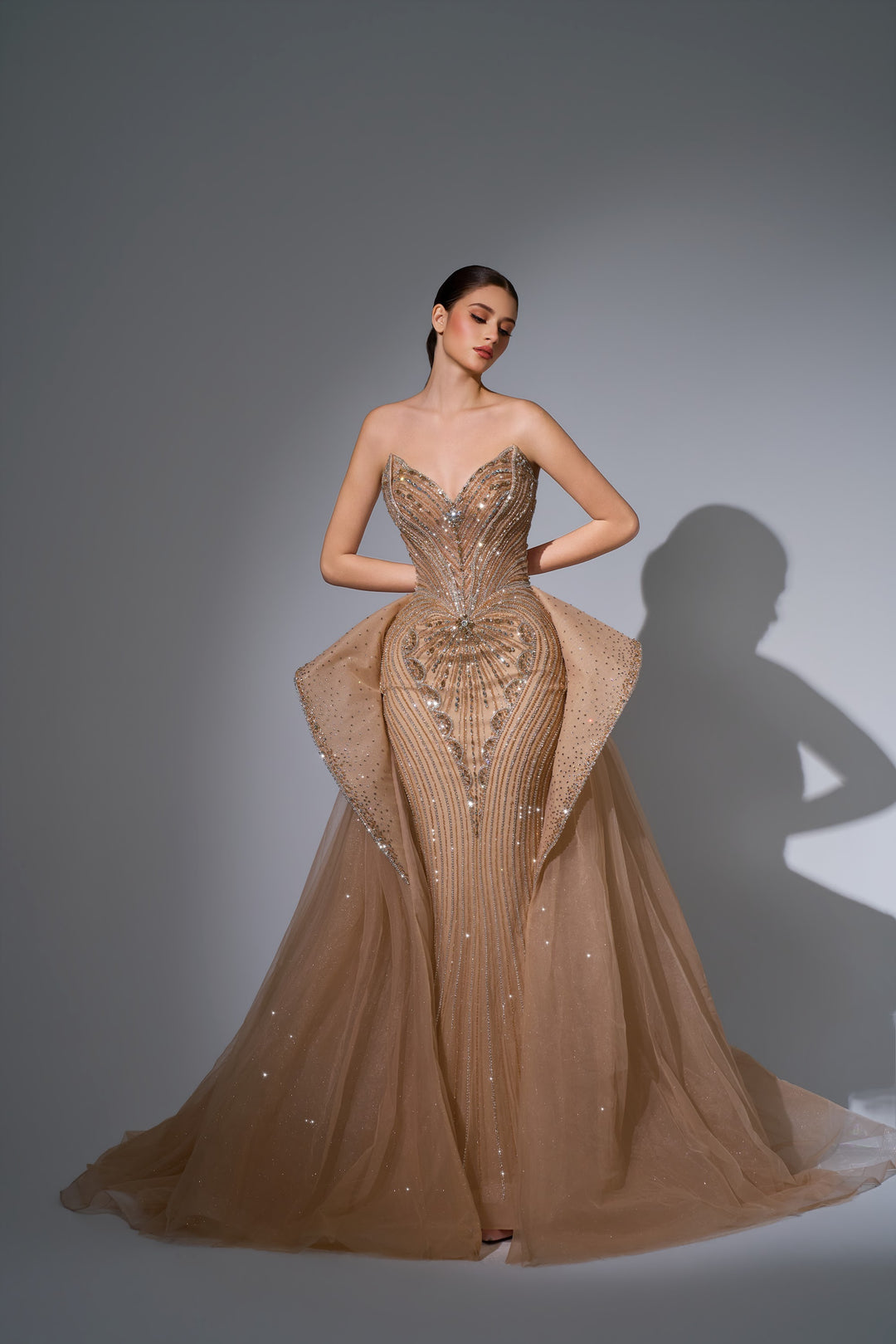 Delilah LD12089 Strapless Plunging Crystal Mermaid Gown with Peplum and Tulle Overskirt - Champagne front view