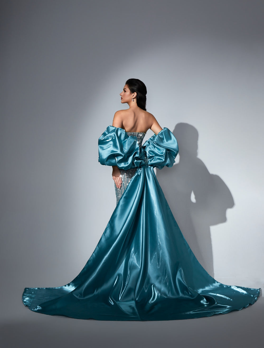 Delilah LD11438 Strapless Beaded Mermaid Gown with Satin Puff Sleeves and Overskirt - Green back view