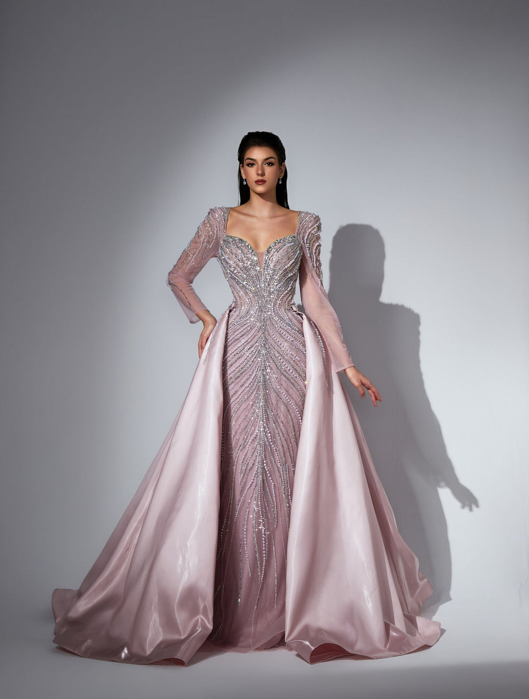 Delilah LD11475 Plunging Illusion Long Sleeve Beaded Corset Sheath Gown with Overskirt - Pink front view